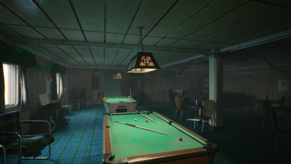 Several pool tables in a dimly lit room with outdate decor